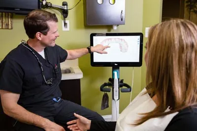 Dr. Cutting showing a patient their dental x-rays at Edgewater Dental Arts